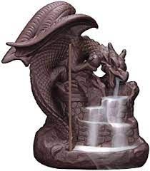 a statue of a dragon drinking water from a fountain