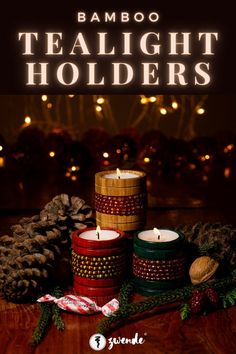 three candles sitting on top of a wooden table next to pine cones and christmas decorations