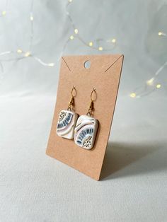 a pair of earrings sitting on top of a card