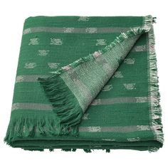 a green and white blanket with fringes on it