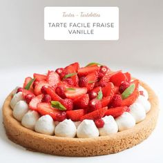 a tarte topped with strawberries and marshmallows on top of a cookie