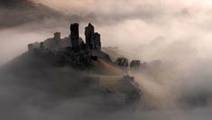 an aerial view of a castle in the clouds