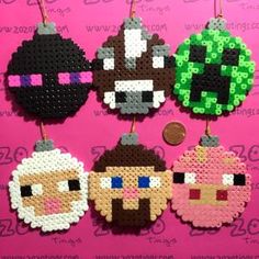 some pixelated ornaments are hanging on a pink wall