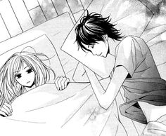 a man and woman laying in bed with their hands on each other's backs