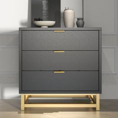 a dresser with two vases on top of it next to a mirror and lamp