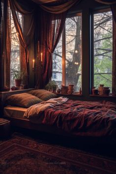 a bed sitting in front of two windows with candles on top of each window sill