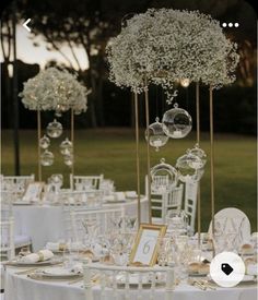 the table is set with white flowers and candles