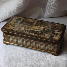 an old wooden box sitting on top of a bed