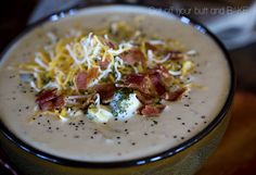 a white bowl filled with food on top of a table