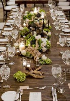 a long table is set with place settings and candles