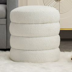 a stack of white towels sitting on top of a rug