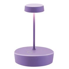 a purple table lamp sitting on top of a white surface