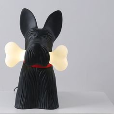 a black dog with a red collar and light up ears