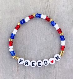 a beaded bracelet with the word freedom written in red, white and blue beads