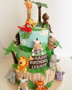 a birthday cake with animals and trees on it's top is for a boy