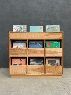 a wooden shelf with books and magazines on it