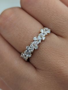 a woman's hand with a diamond ring on it