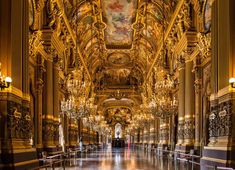 an ornately decorated hall with chandeliers and lights