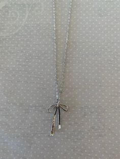 "Sleek and pretty silver tone bow knot necklace.  Simplistic design makes it a versatile piece for any outfit.   Pendant measures 1 1/4\" L X 3/4\" W and is on an 18\" chain.   ★ Want to see more?  Please visit my shop at: https://www.etsy.com/shop/DesignsByPeg" Minimalist Silver Jewelry With Bow, Adjustable Silver Necklace With Ribbon, Silver Adjustable Necklace With Ribbon, Silver Sterling Silver Necklace With Bow, Dainty Silver Necklace With Bow, Adjustable Silver Necklace With Bow, Silver Jewelry With Satin Bow For Gifts, Silver Jewelry With Satin Bow As Gift, Silver Bow Necklace