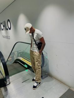 a man standing in front of an escalator