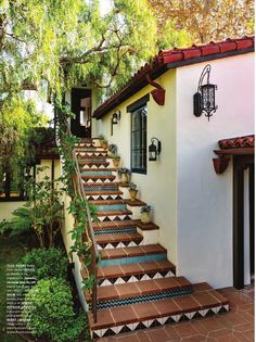 an outdoor staircase with tiled steps leading up to the house