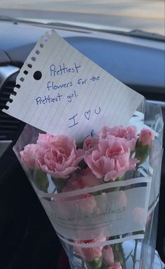 pink carnations in a vase with note attached to it