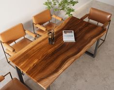 a wooden table with chairs around it and a book on the table next to it