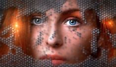 a woman with blue eyes and orange hair is shown through a meshed screen pattern