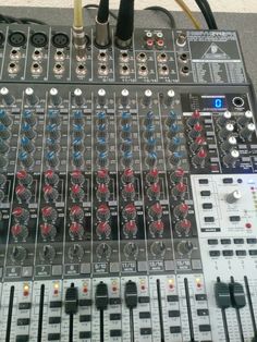 an electronic mixing console with many knobs