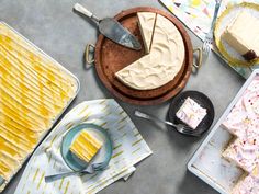 a table topped with lots of different types of cakes and desserts next to each other