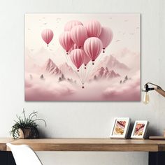 there are many pink balloons flying in the sky above the mountains and clouds on this wall