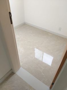 an empty room with white walls and flooring in the corner is seen from outside