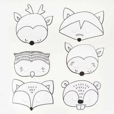 paper cut out of animals with eyes and nose, including a fox, a raccoon, and an owl