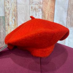 a close up of a red hat on a mannequin