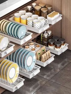 the dish rack is organized with dishes and cups