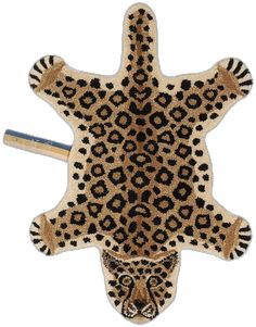 an animal shaped rug with black and brown spots on it's face, next to a pencil