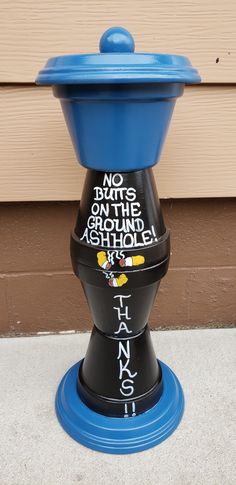 a blue and black fire hydrant with writing on it