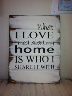 a wooden sign that says, what i love most about my home is who i share it with