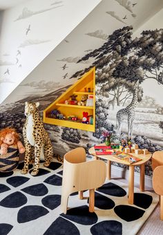 the children's room has an animal theme on the wall