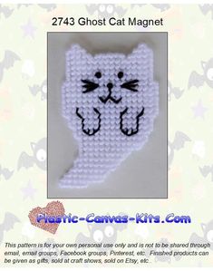 a white cat with black eyes on it's face is made out of plastic beads