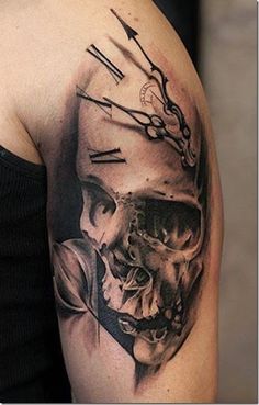 a man's arm with a clock and skull tattoo on the left side of his arm