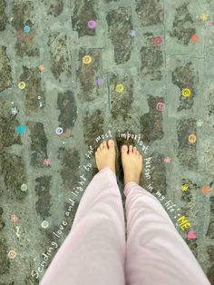 a person standing on the ground with their feet up in front of some colorful buttons