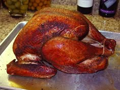 a whole turkey sitting on top of a metal pan