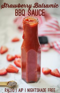 strawberry balsamic bbq sauce in a glass bottle with strawberries scattered around