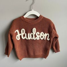 Custom hand-embroidered sweaters for your baby or toddler. Available in size newborn-big kid size 12Y! Perfect for baby shower gifts, birth announcements, gender reveals, pregnancy announcements, or keepsake gifts.  Sweaters can be customized with your child's name, phrases, and designs. Feel free to reach out if I there is something I can create for you that you don't see! RUSH MY ORDER is available! Add to your cart in addition to your sweater order. Message me for how to expedite your order.  Care instructions for your sweater: HAND WASH IN COLD WATER. If you need to machine wash, turn your sweater inside out and place in a mesh delicates bag. Wash on cold, gentle cycle. Lay flat to dry. Disclaimer:  * If you want the name on your sweater kept private, please include that in your note t Embroidered Sweaters, Appliqué Embroidery, Keepsake Gifts, Gender Reveals, Kids Jumpers, Toddler Sweater, Monthly Milestone, Pregnancy Announcements, Embroidered Sweater