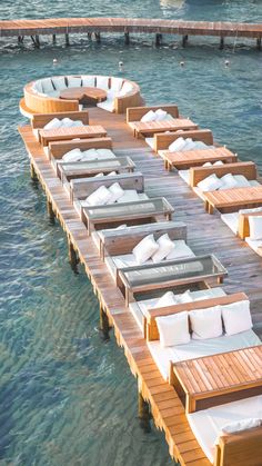 several lounge chairs are lined up on a dock