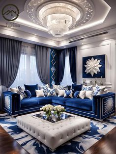 a blue and white living room with couches, coffee table and chandelier