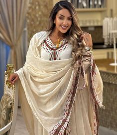 Get this dress for extra luxury for it has a long, flowing design with a modest, and elegant cut. This dress is often worn for special occasions such as religious ceremonies, weddings, or cultural celebrations Material Cotton Thread Estimated delivery : 2weeks to 3weeks Contact WhatsApp +1(304)-306-2784Email: contact@ethiopian.store Eritrean Dress, Habesha Dress, Ethiopian Traditional Dress, Ethiopian Dress, Indigenous Tribes, Traditional Embroidery, Flow Design, Wedding Dress Chiffon, Red And Brown