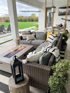 an outdoor living room with couches and fire pit