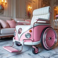 a pink and white vw buggy is sitting in the middle of a living room